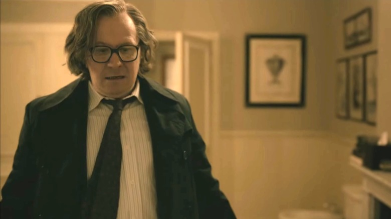 Gary Oldman's Jackson Lamb looks worried as he stands in Charles Partner's bathroom in Slow Horses