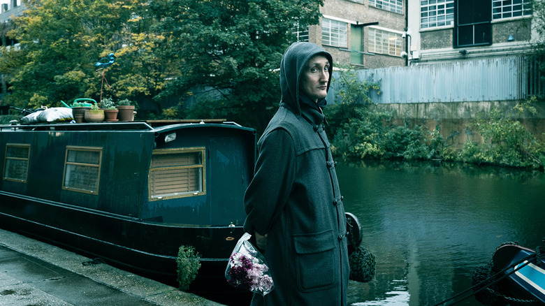 Thomas Brooke's J.K. Coe stands by a canal in Slow Horses