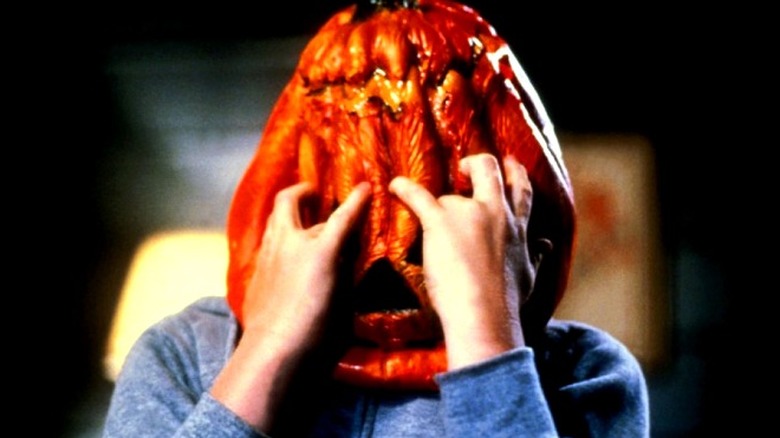 kid clawing at pumpkin mask Halloween III: Season of the Witch