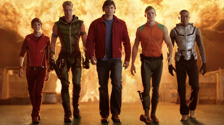 The Justice League assembles on Smallville as Impulse, Green Arrow, Clark Kent, Aquaman, and Cyborg walk away from an explosion