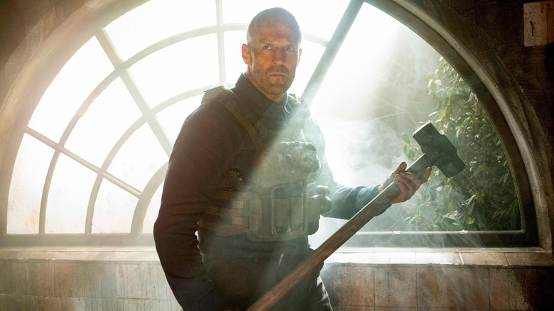 Jason Statham's Levon Cade holding a sledgehammer in A Working Man