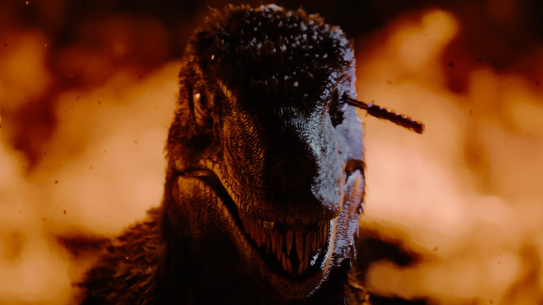 The raptor with a knife in its eye surrounded by fire in Primitive War