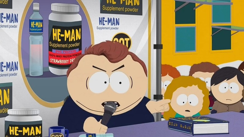 Cartman angrily adresses a crowd surrounded by supplement powder ads in South Park