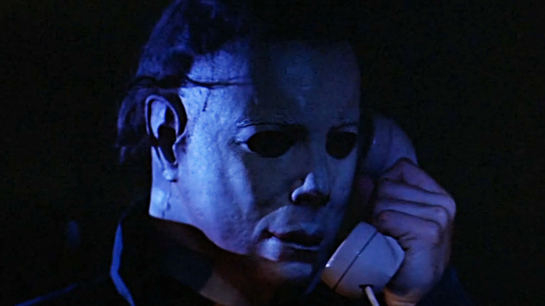 Michael Myers holds a phone to his ear in Halloween