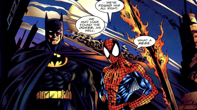Batman and Spider-Man stand side by side as they converse in a panel from Spider-Man and Batman