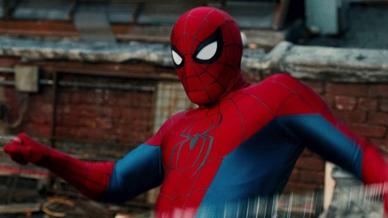 Tom Holland as Peter Parker wearing his superhero suit and holding two lines of webbing in Spider-Man: Brand New Day