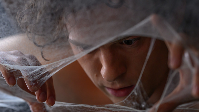 Tom Holland as Peter Parker covered in a web cocoon in Spider-Man: Brand New Day