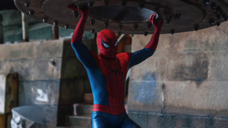 Spider-Man lifting a very heavy object in Spider-Man: Brand New Day