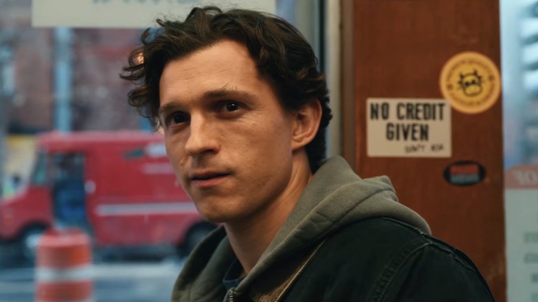 Peter Parker looks at an oblivious Ned and MJ with a smile on his face in Spider-Man: Brand New Day