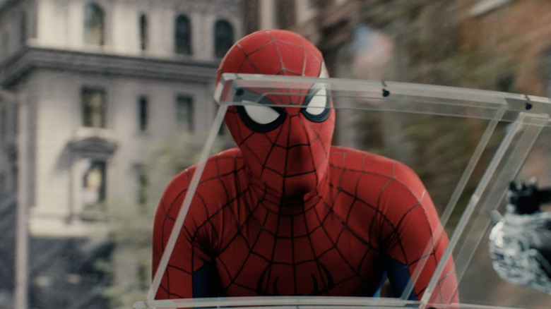 Spider-Man crouching on the front of a vehicle in Spider-Man: Brand New Day