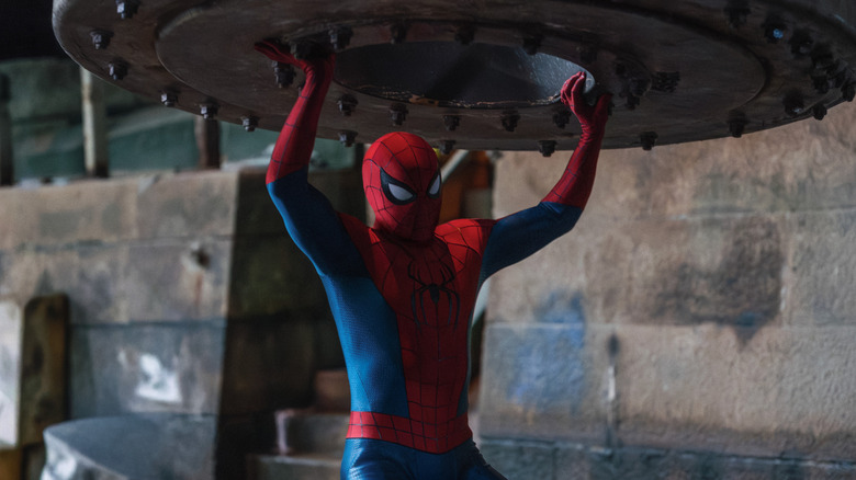 Spider-Man raising a metal object over his head in Spider-Man: Brand New Day