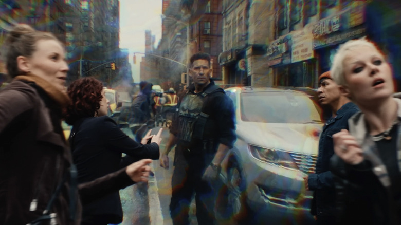 The Punisher stands in the street surrounded by civilians frozen by Jean Grey's mutant powers in Spider-Man: Brand New Day
