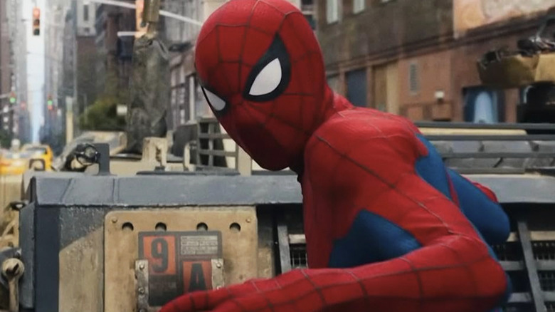Spider-Man on top of a tank, looking backward over his shoulder toward the camera, in Spider-Man Brand New Day