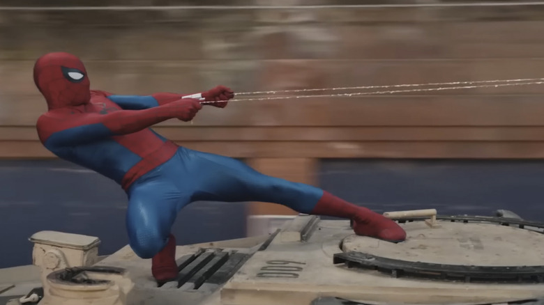 Spider-Man leaning back, hanging on to two strands of webbing, in Spider-Man: Brand New Day