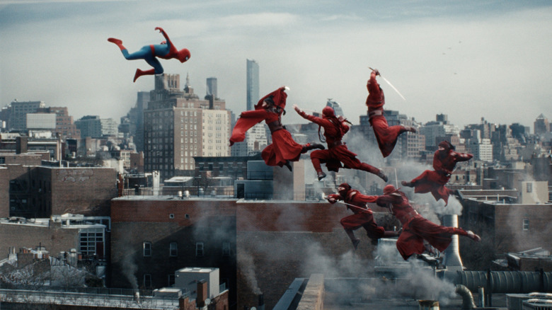 Tom Holland as Peter Parker flying through the air and fighting a group of ninjas dressed in red in Spider-Man: Brand New Day