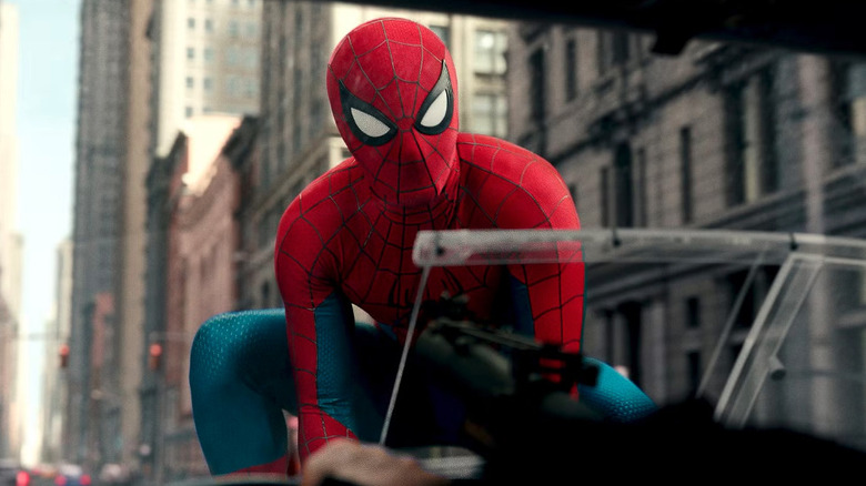 Spider-Man (Tom Holland) crouched on The Punisher's van hood in Spider-Man: Brand New Day