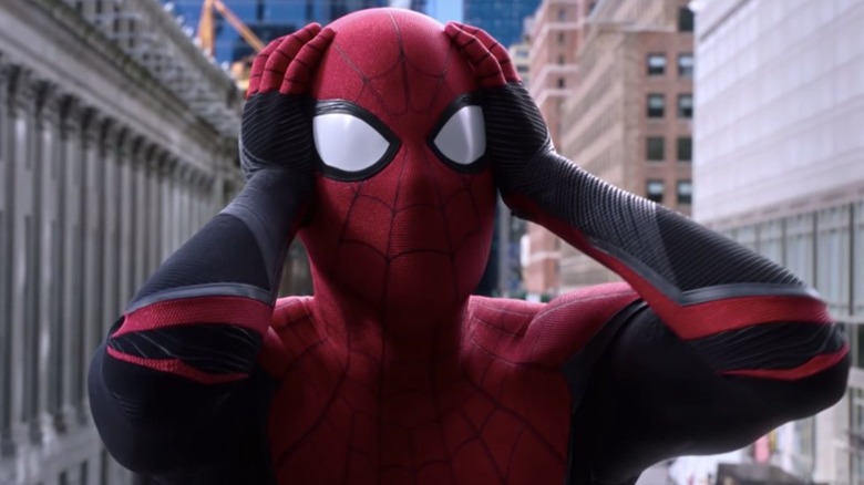 Spider Man grabs head, surprised