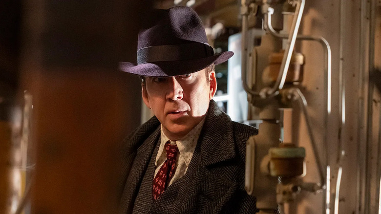 Nicolas Cage as Ben Reilly with his hat pulled down low over his face in Spider-Noir