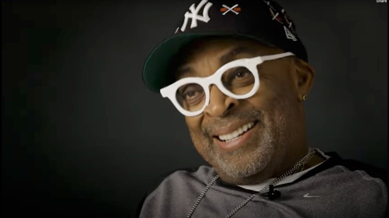 Spike Lee dons a New York Yankees ballcap and white, lensless glasses for an interview