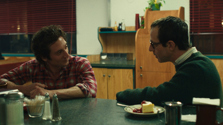 Bruce Springsteen and Jon Landau sit at a diner counter in Springsteen: Deliver Me from Nowhere