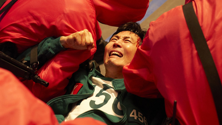 Gi-hun is hauled away by guards in Squid Game season 3