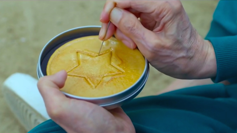 Dalgona candy being carved in Squid Game