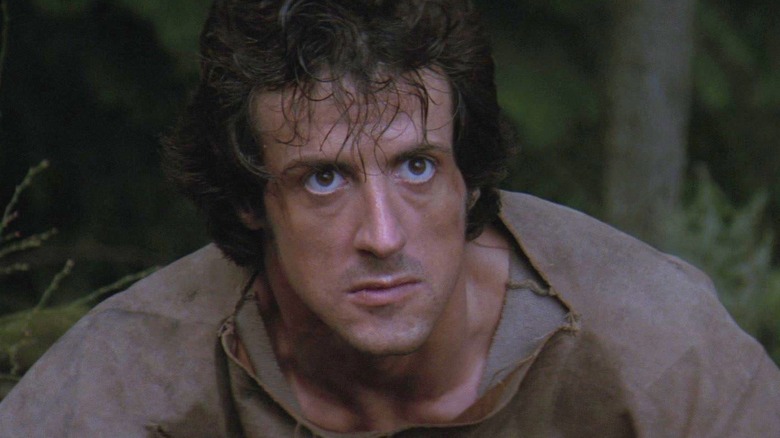 John Rambo looking intense in the woods in First Blood