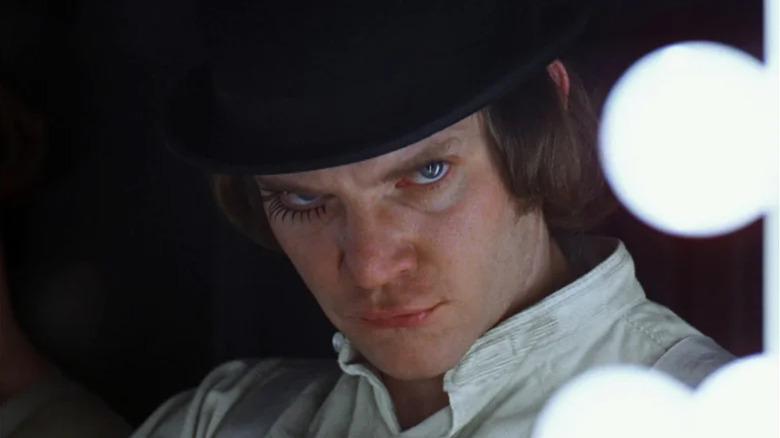 Alex DeLarge (Malcolm McDowell) sneers at himself in a mirror in A Clockwork Orange