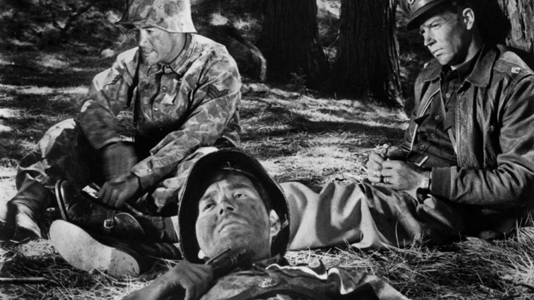 The Sergeant, the Private, and the Captain sitting in the woods, a scene from Fear and Desire.