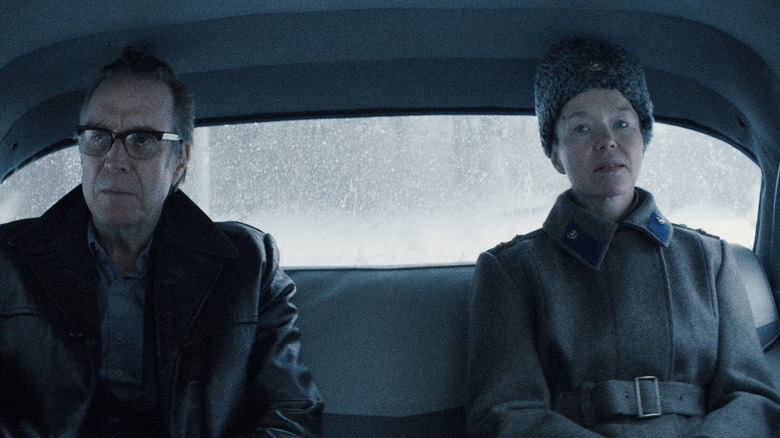 The Chief Designer sitting next to KGB leader Lyudmilla Raskova in a car in Star City