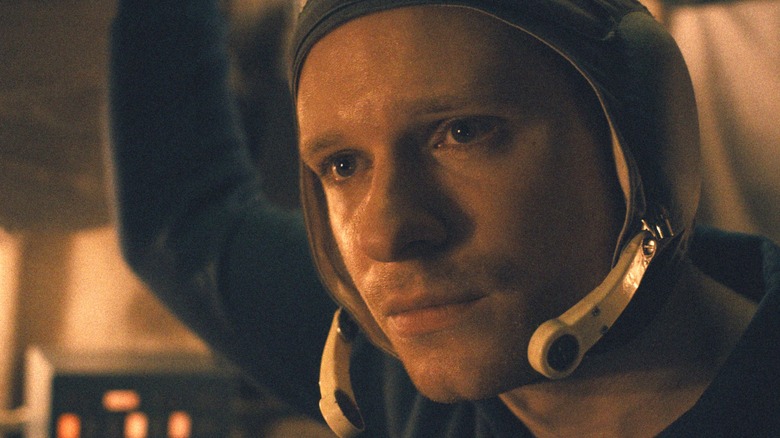 Solly McLeod as Sasha Polivanov wearing a Soviet headset inside a space module in Star City
