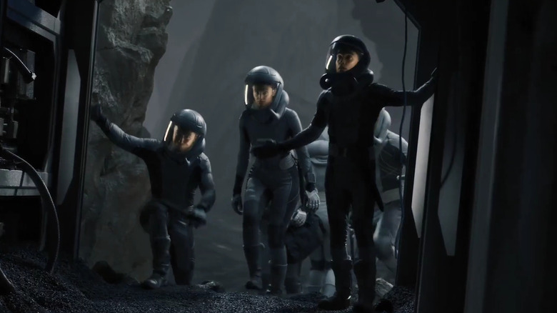 Christie Burke as Lieutenant Garnet leading an Ark One team wearing space suits on The Ark