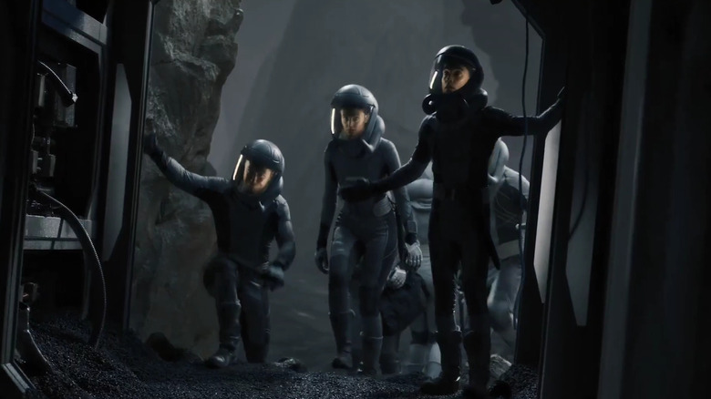 Christie Burke as Lieutenant Garnet leading an Ark One team wearing space suits on The Ark