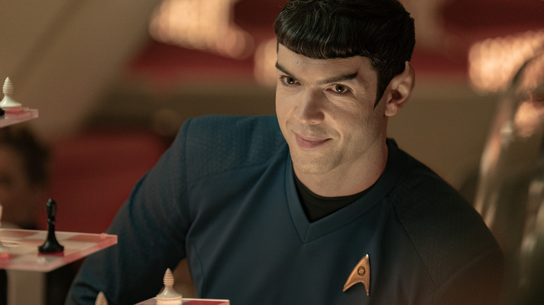 Ethan Peck as Spock smiling in front of a three-dimensional chess board on Star Trek: Strange New Worlds
