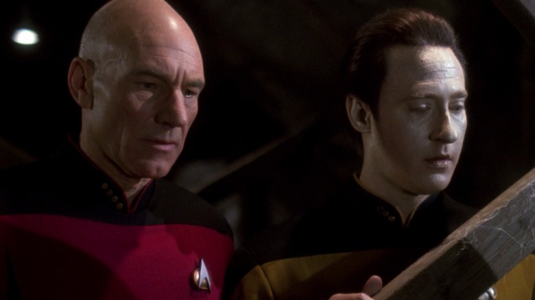 Patrick Stewart's Picard and Brent Spiner's Data look curiously at something offscreen in Star Trek: The Next Generation