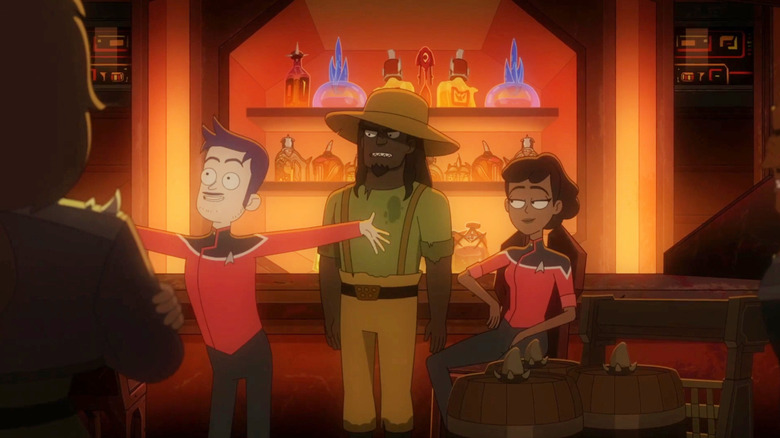 Boimler looking excited in a Klingon bar while Ma'ah and Mariner watch on Star Trek: Lower Decks