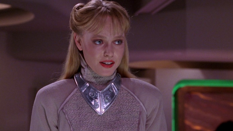 Lisa Wilcox as Yuta, a blonde alien woman wearing a silver outfit, in Star Trek: The Next Generation