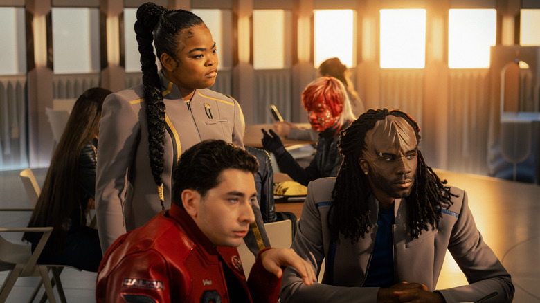 Kerrice Brooks as SAM, Romeo Carere as Ocam, and Karim Diané as Jay-Den hanging out in a cafeteria in Star Trek: Starfleet Academy