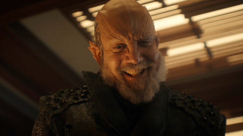 Paul Giamatti's Nus Braka grinning wickedly on Star Trek: Starfleet Academy