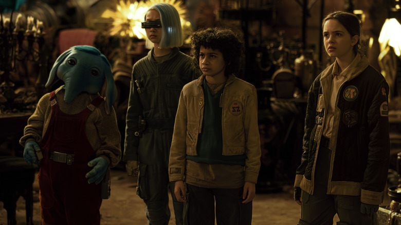 Robert Timothy Smith as Neel standing next to Kyriana Kratter as KB, Ravi Cabot-Conyers as Wim, and Ryan Kiera Armstrong as Fern in Star Wars: Skeleton Crew