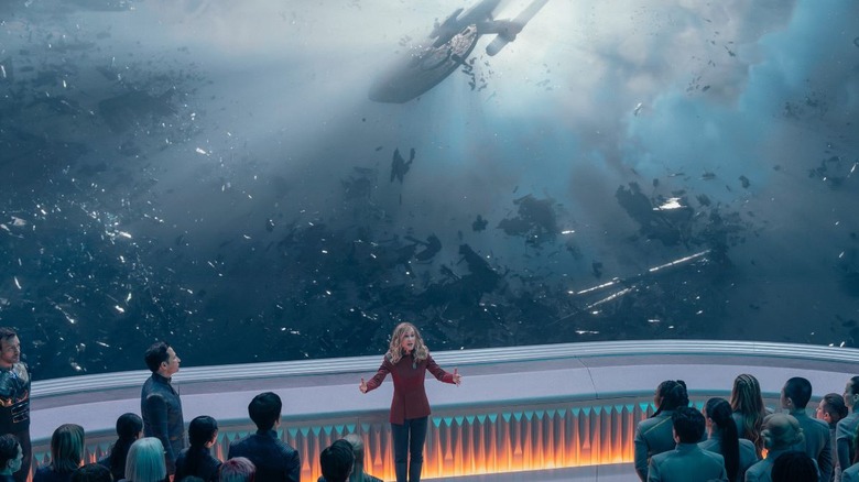 Nahla Ake speaking in front of a starship graveyard observation window in Star Trek: Starfleet Academy