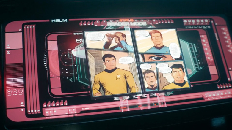 Screenshot from season 1, episode 6 of Star Trek: Starfleet Academy depicting a computer screen with comic book pages displayed on its monitor, depicting Starfleet officers in 23rd century uniforms