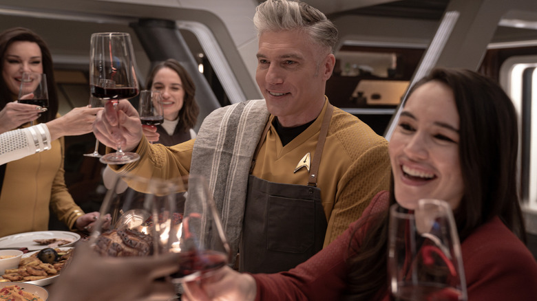 Rebecca Romijn as Una, Melanie Scrofano as Batel, Anson Mount as Capt. Pike, and Christina Chong as La'an celebrating a toast in Strange New Worlds season 3