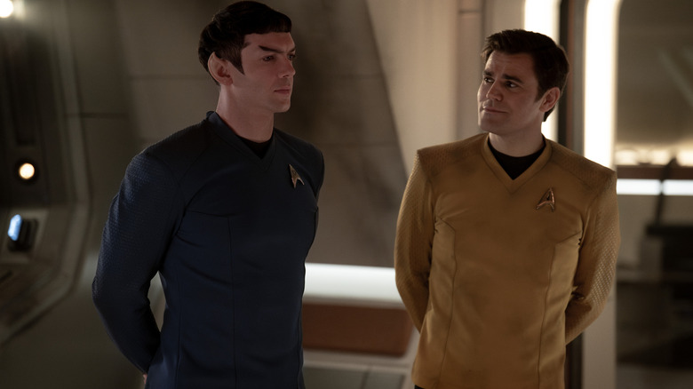 Ethan Peck as Spock and Paul Wesley as James T. Kirk standing next to each other in Star Trek: Strange New Worlds season 3