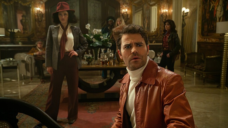 Christina Chong's La'An AKA Amelia Moon stands posed in 20th century clothes while Paul Wesley's Maxwell Saint, foregrounded, looks confused (in Star Trek: Strange New Worlds)