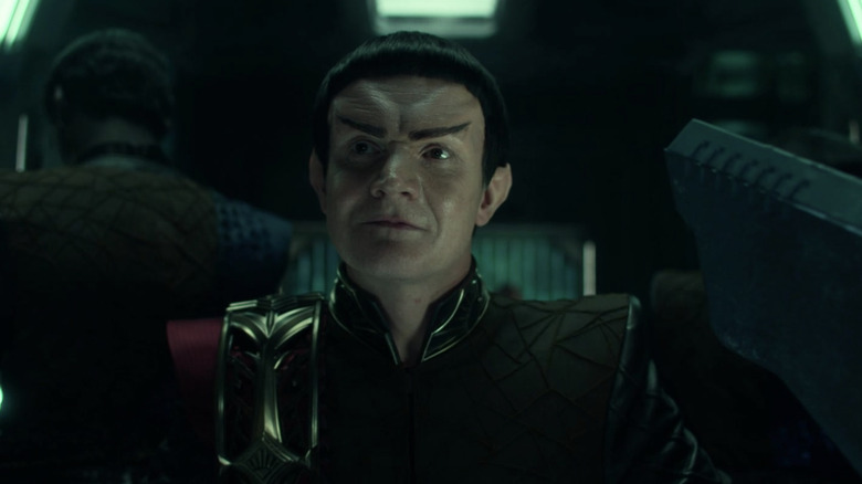 A Romulan commander sitting down in the Star Trek: Strange New Worlds episode A Quality of Mercy