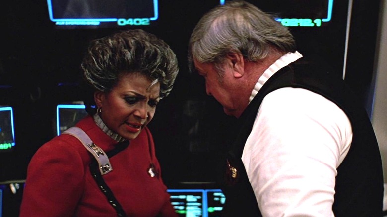 Uhura looking down and standing opposite Scotty, who is looking down at her in Star Trek V