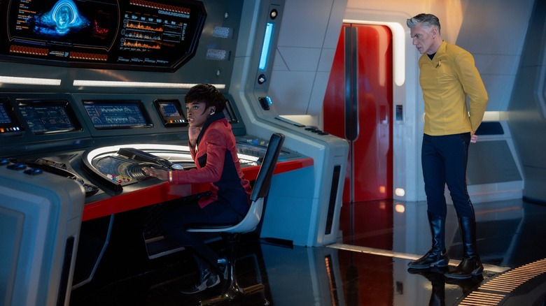 Uhura at the communications station with Captain Pike looking on on Star Trek: Strange New Worlds