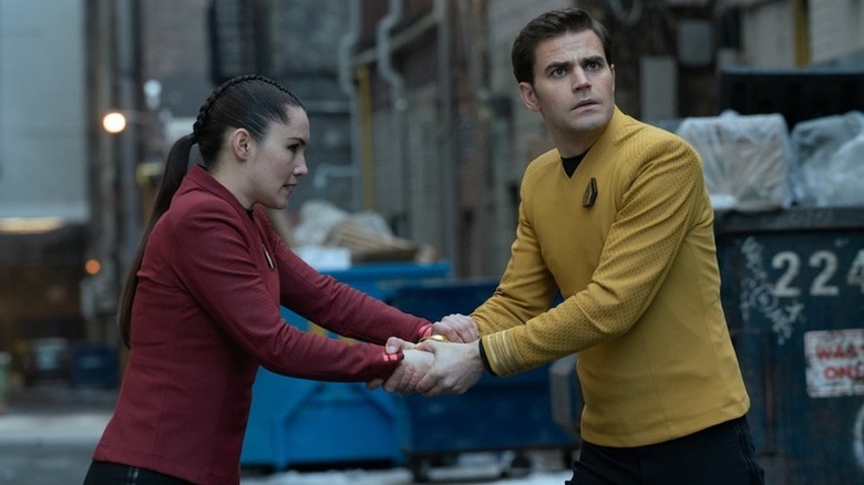 La'an Noonien Singh and Jim Kirk in a 21st century Toronto alley gripping each other's hands in Star Trek: Strange New Worlds