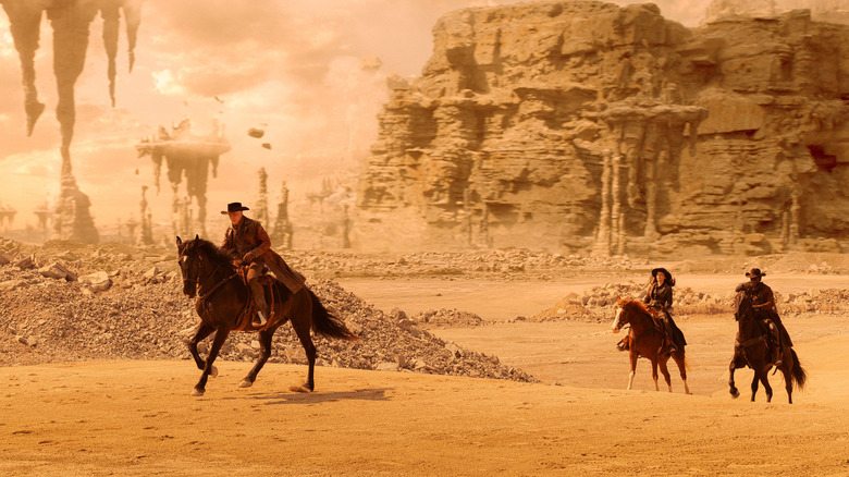Captain Pike, La'An Noonien-Singh, and Dr. M'Benga wearing cowboy gear and riding horeses in a desert environment in Star Trek: Strange New Worlds